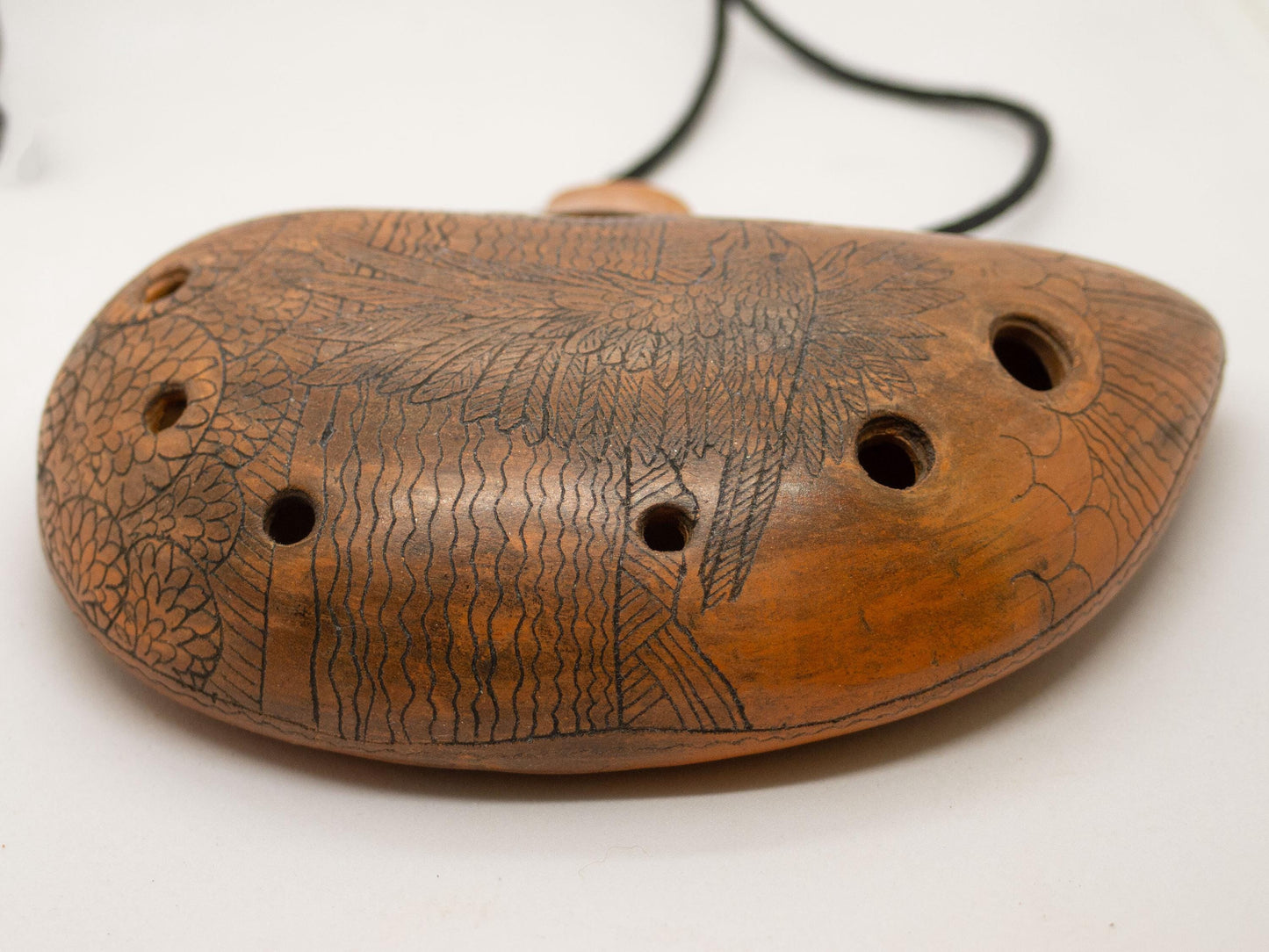 Ceramic Ocarina Journey of an Old Raven. Handmade Clay Flute with an Engraved Drawing of a Flying Raven in a Landscape.